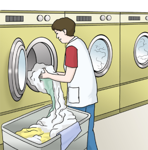 Auf dem Bild arbeitet eine Person in der Wäscherei – sie holt frisch gewaschene Wäsche aus der Waschmaschine.