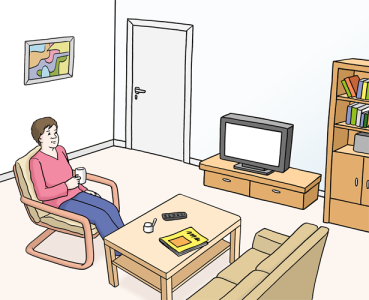 Eine Frau sitzt entspannt in ihrem Wohnzimmer.