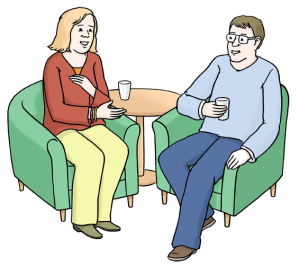 Auf dem Bild unterhalten sich zwei Menschen freundlich miteinander.