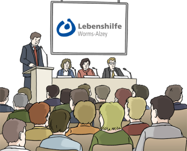 Auf dem Bild halten mehrere Personen vorne eine Rede oder sprechen auf einer Veranstaltung der Lebenshilfe Worms-Alzey – viele Menschen hören zu.